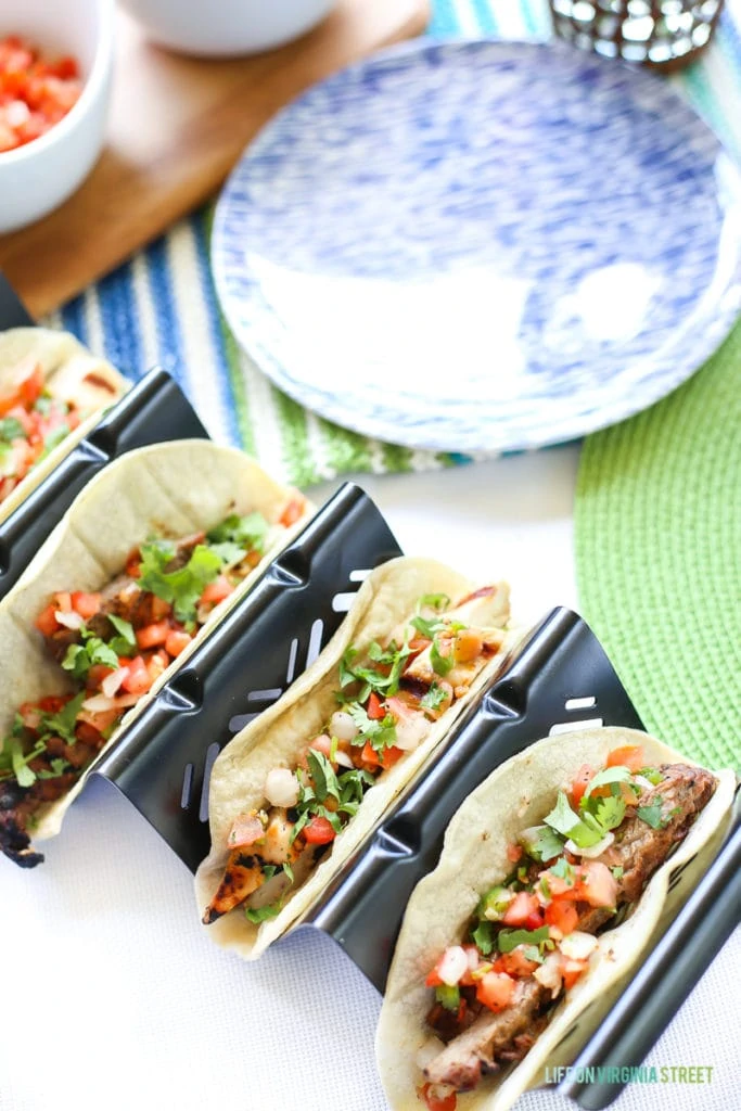 Up close picture of the tacos in taco containers on the table.