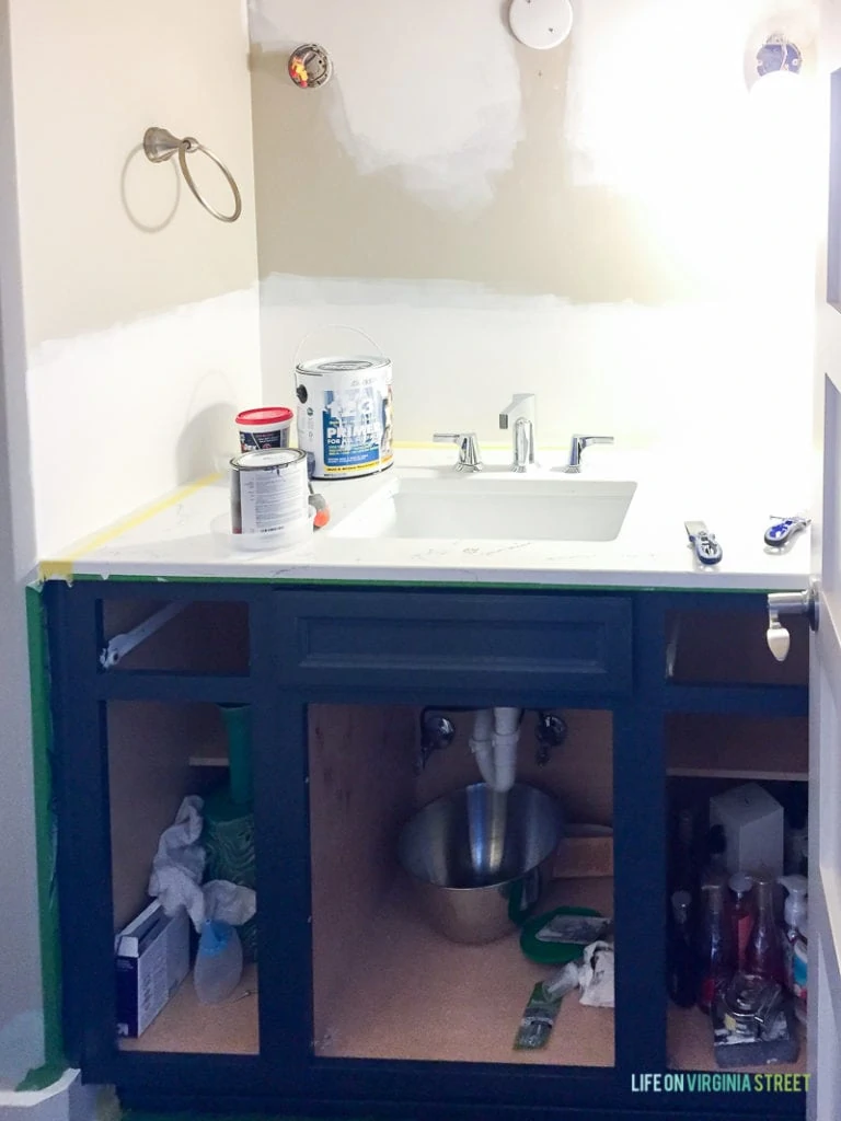 Painting the rest of the cabinet in the bathroom.