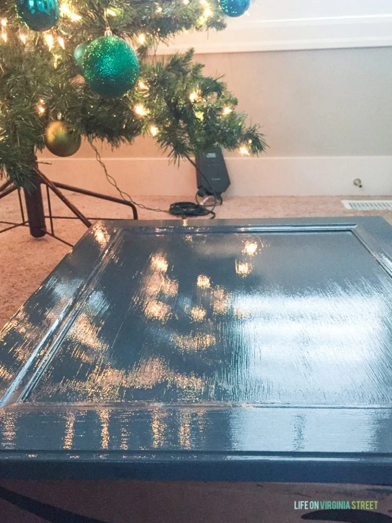 Freshly painted door in a medium blue color drying under the Christmas tree.