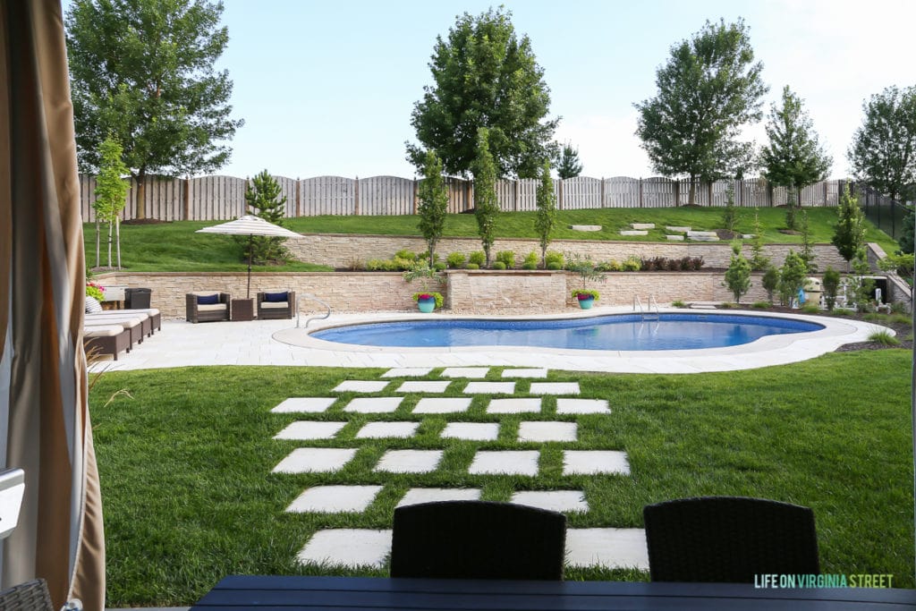 The fence around the pool and large trees.