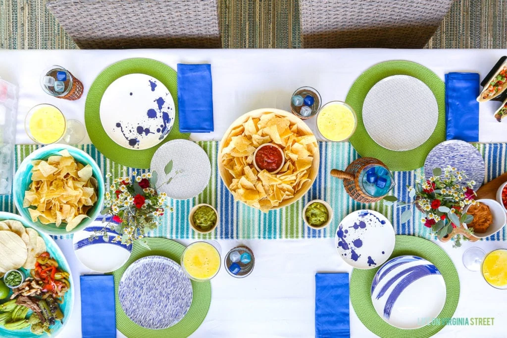 Grilled taco fixings on a blue, white and green tablescape. Striped table runner and green woven placemats. Includes fresh margarita recipe. 