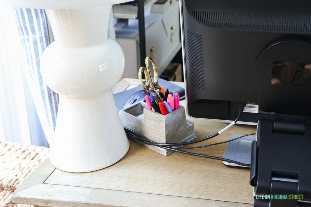 Up close picture of the computer cords on the desk.