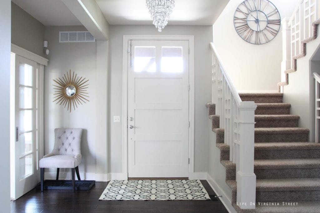 After a coat of Behr Castle Path paint and a few wall decorations, our entryway is looking brighter.