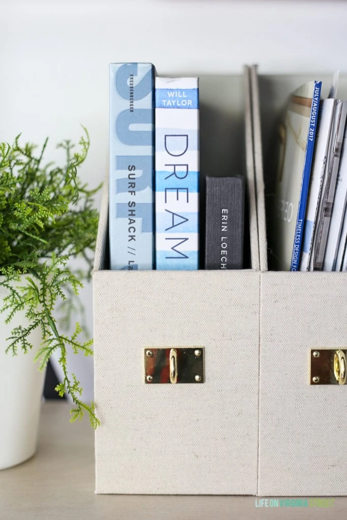 Linen and gold office containers with books in them.