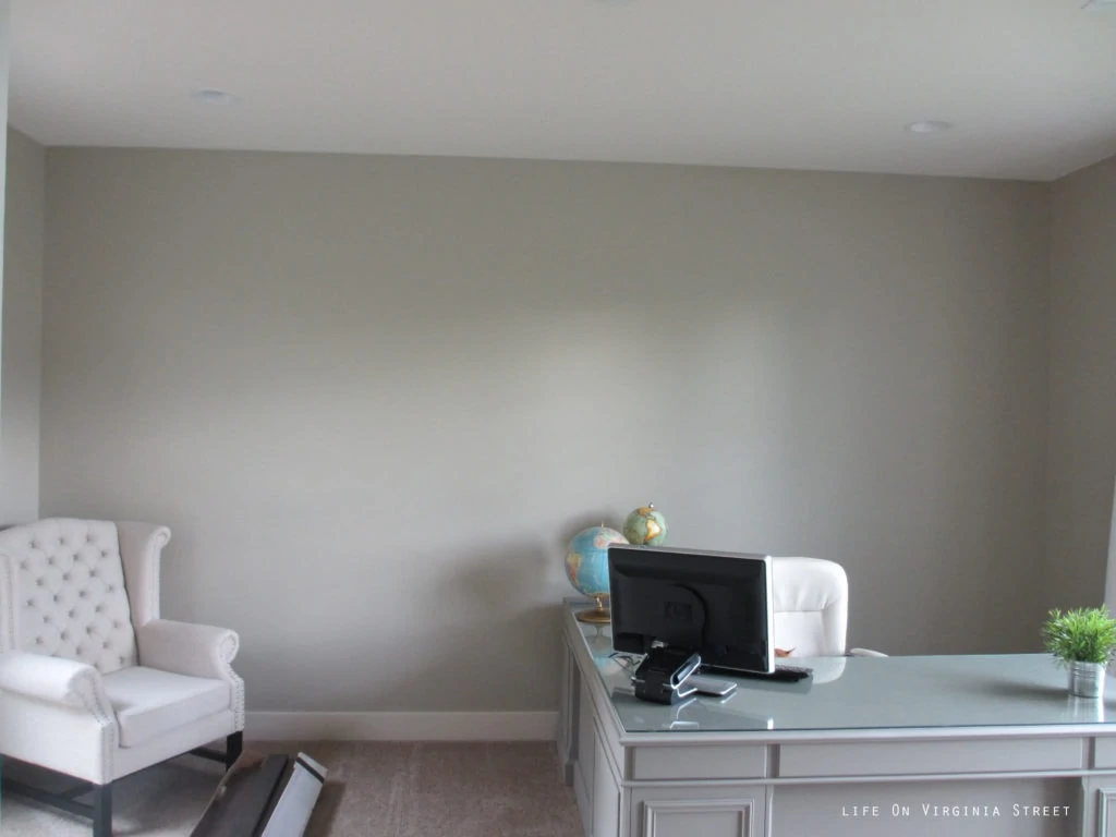 Lightened up walls in our office using Behr's Castle Path paint. 