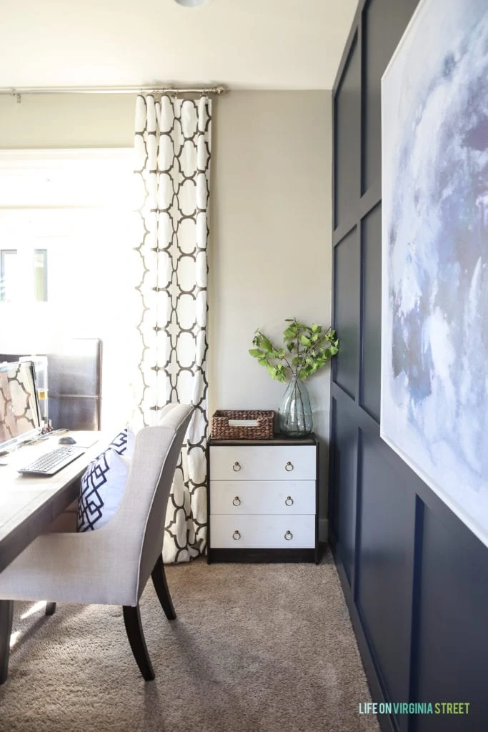 White office chair, a small three drawer hutch beside the desk with a plant on it.