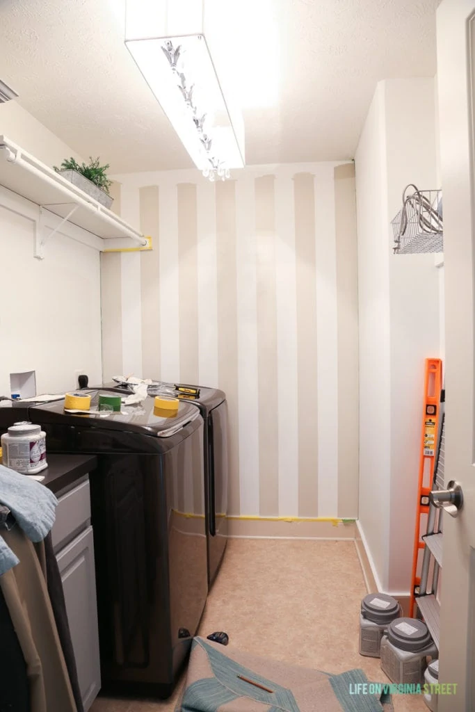 The beige striped buffalo wall in laundry all painted.