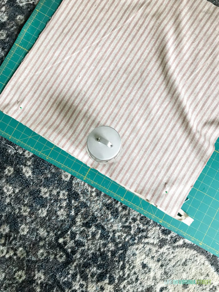 Laying out the fabric on the carpet for cutting.