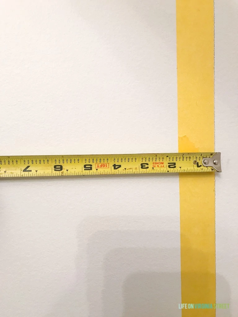 The yellow tape on wall and a measuring tape.