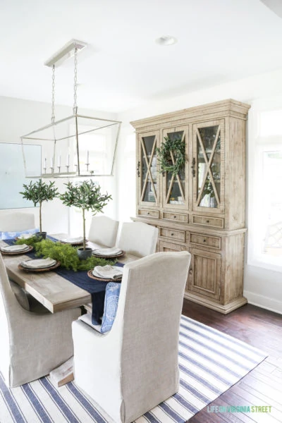Blue and white dining room with reclaimed wood dining room hutch. This post offers several alternatives to this gorgeous piece, at a variety of price points.