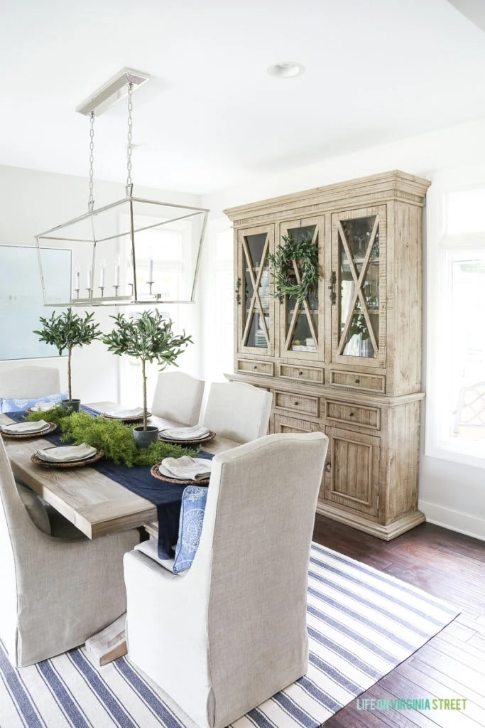 Blue and white dining room with reclaimed wood dining room hutch. 