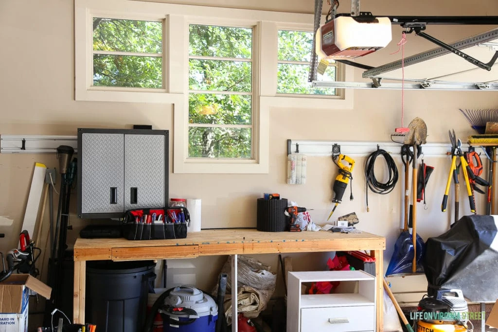 Inside of garage with workbench, and tools hanging on the wall.