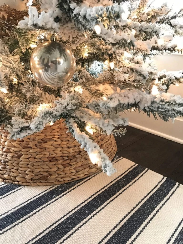 My new pre-lit Christmas tree with the woven tree skirt and striped rug - perfect beach vibe!