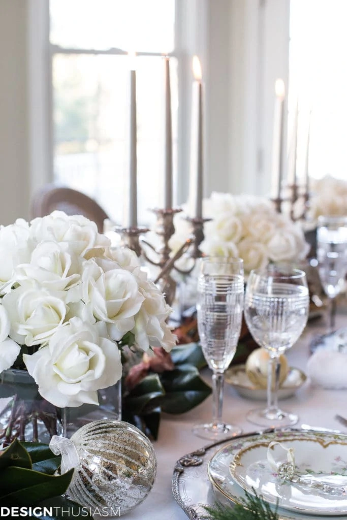 Christmas tablescape from Designthusiasm with white roses and tapers.