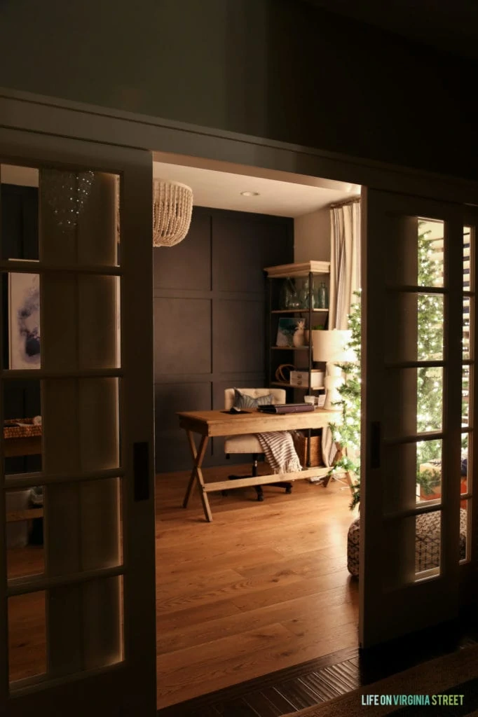 Looking into the office with Christmas tree in the corner lit up.