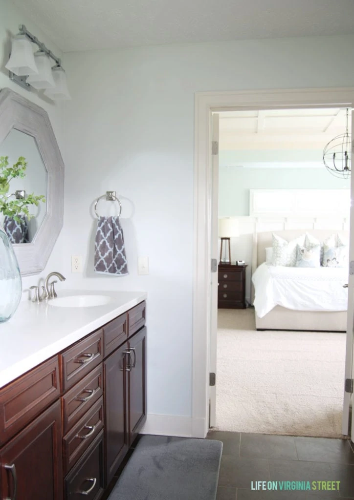 The master bathroom with it painted white and a bright mirror.