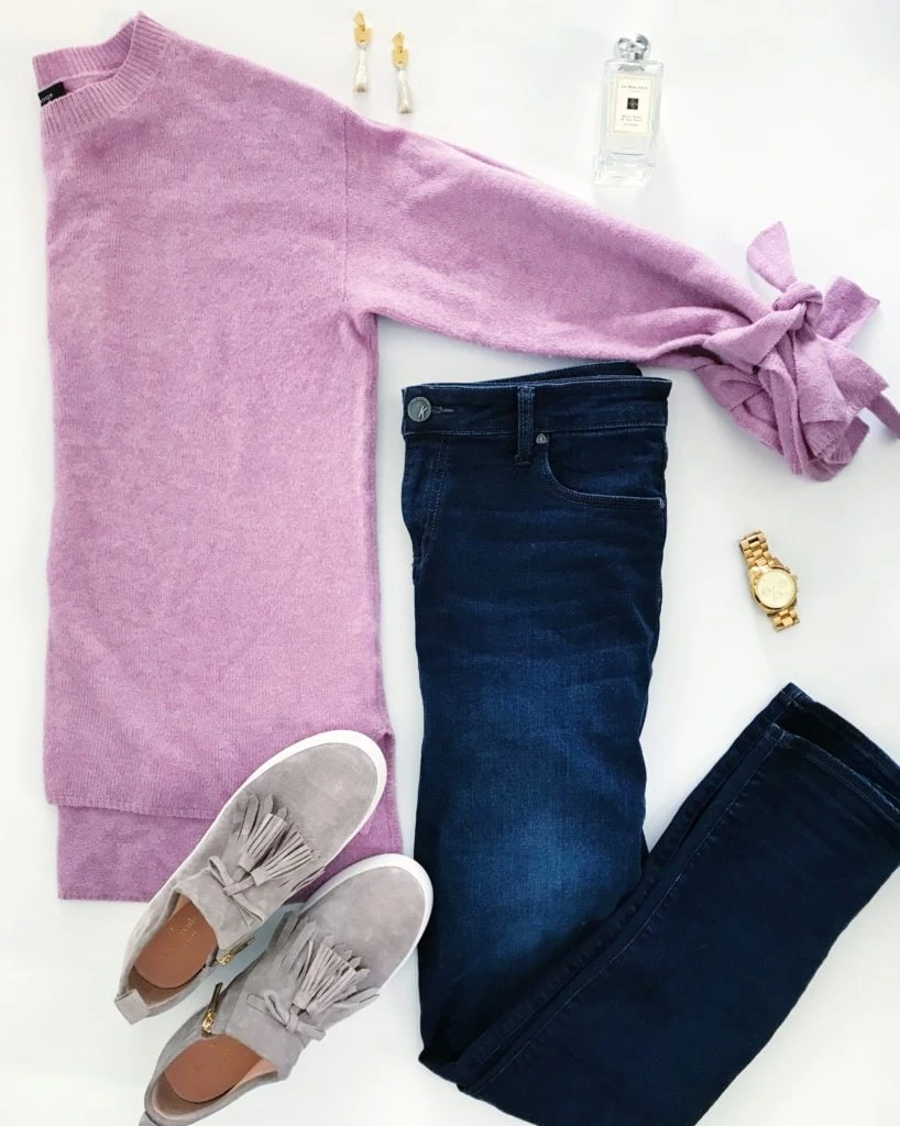 Soft pink purple sweater with tie-sleeves, dark denim skinny jeans, suede tassel sneakers, gold watch, gold and tassel earrings and Jo Malone perfume. The perfect outfit for late winter into early spring!