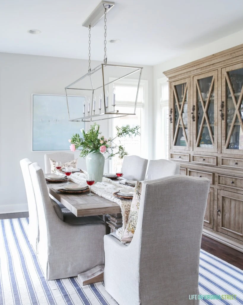 A blue and white striped rug in the dining room.