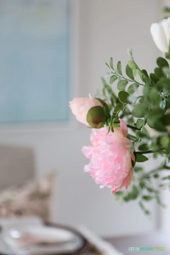 Faux blush pink peony stem in the middle of the table.