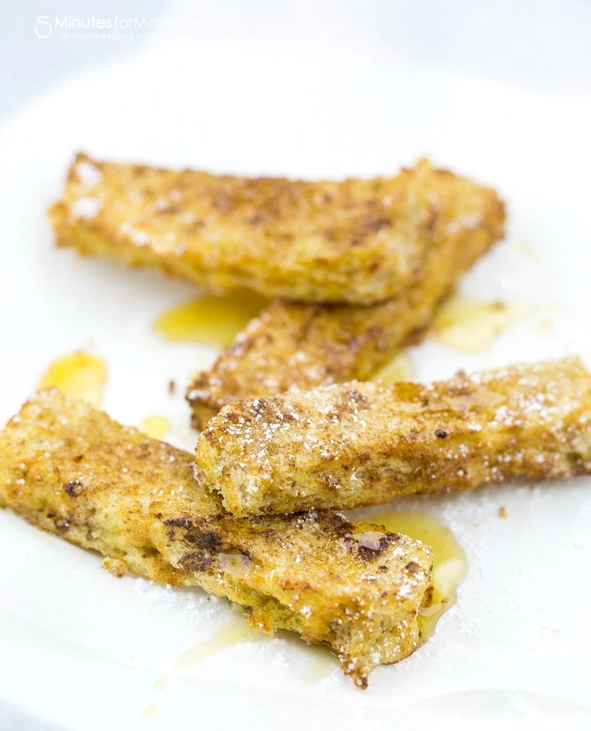 French toast sticks on the counter with icing sugar on top.
