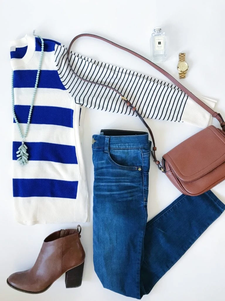 Mixed blue and white stripes sweater paired with skinny jeans, brown booties, a leather crossbody bag, tassel bead necklace and a gold watch.