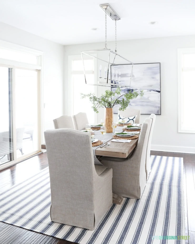 A navy blue striped rug in a coastal dining room.