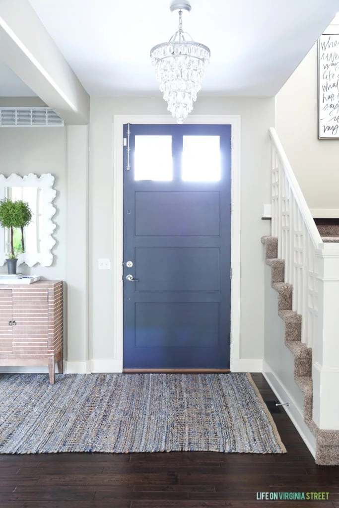 Navy blue and white spring entryway as part of a blue and white spring home tour. Front door color is Benjamin Moore Hale Navy.