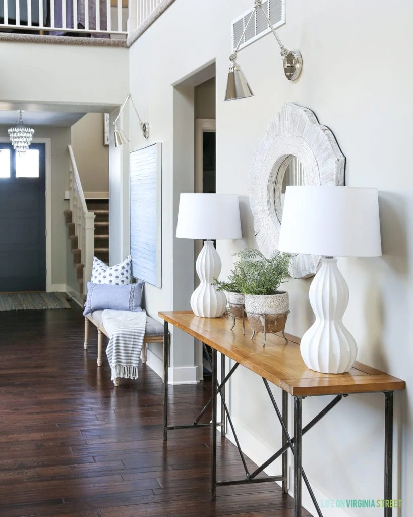 Entryway hallway table vignette. Beautiful blue, white and natural wood accents with maidenhair fern plants.