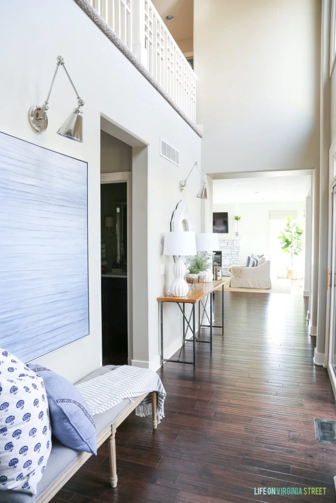 Bright entryway hallway with navy blue and white accents.