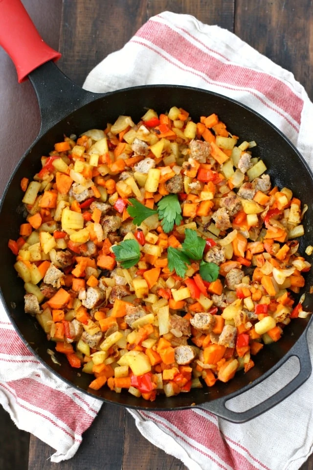Sweet potato and sausage scramble in a skillet.