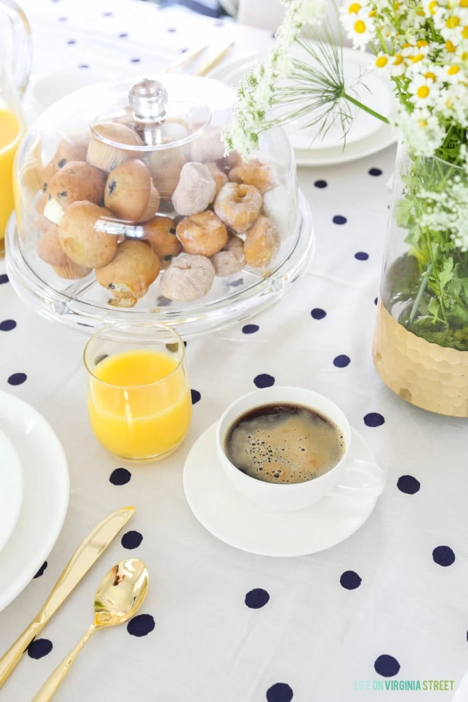 Donuts, and muffins in the covered clear cake stand.