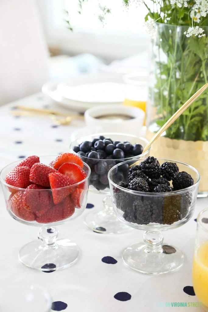 Up close of the strawberries, blackberries, and blueberries in clear bowls.