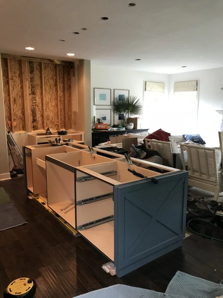 Putting together the kitchen island that is navy blue.