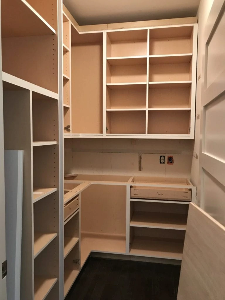 Installing the pantry shelves.