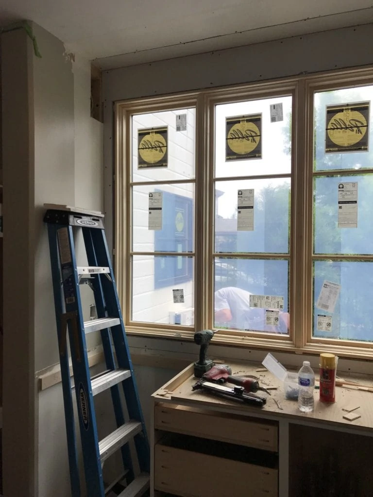 A step ladder beside the newly installed window in the kitchen.