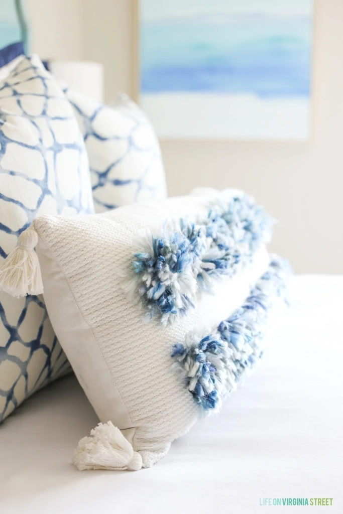 I love this lumbar tassel pillow with blue and white yarn poms!
