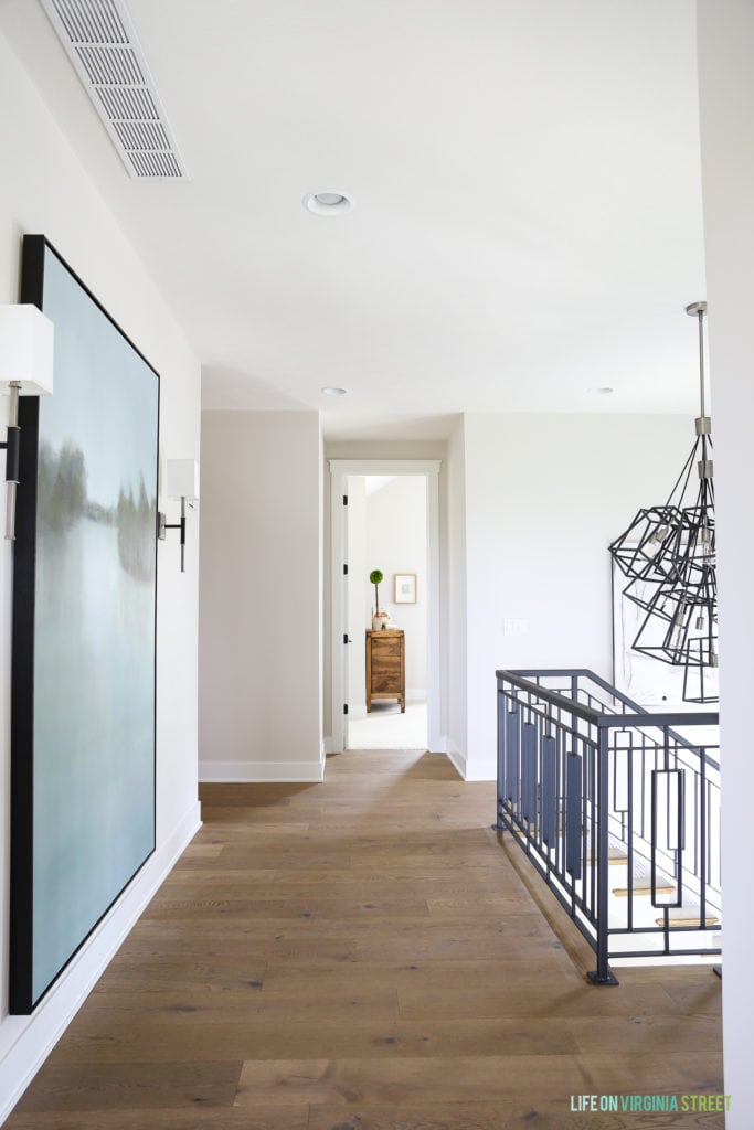 Light wooden floors down the hallway of the upper level of the house.