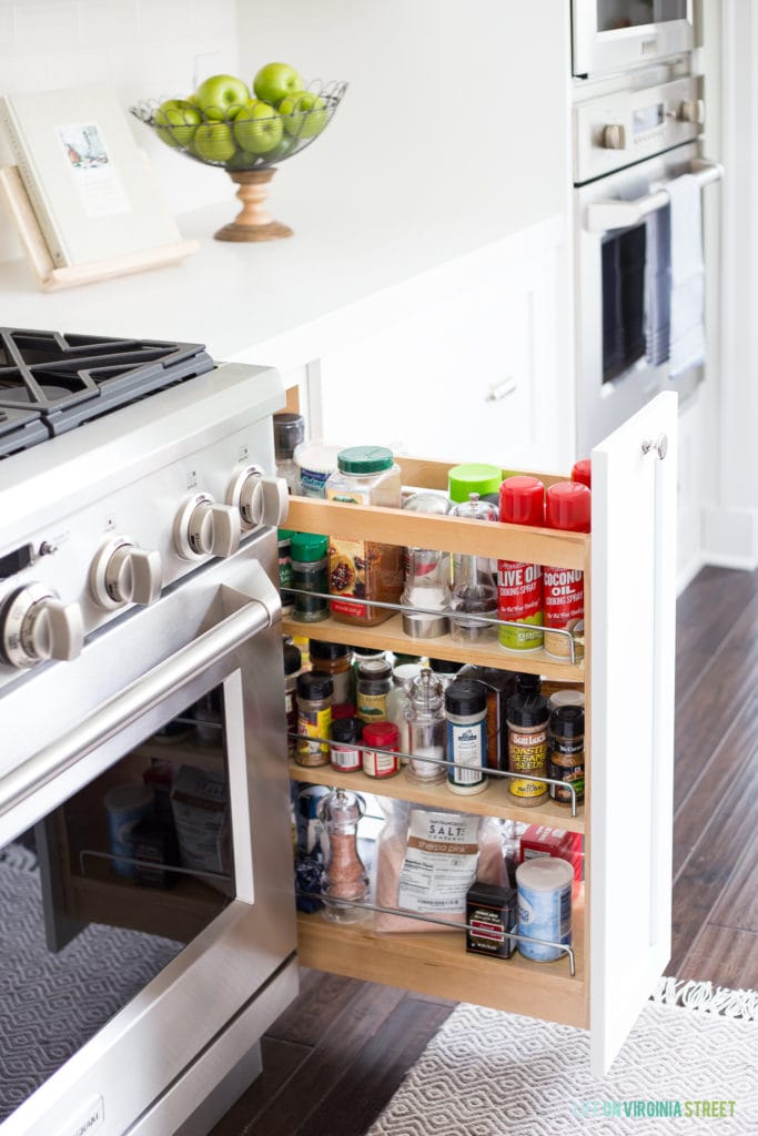 White kitchen cabinets with a pull-out spice rack!