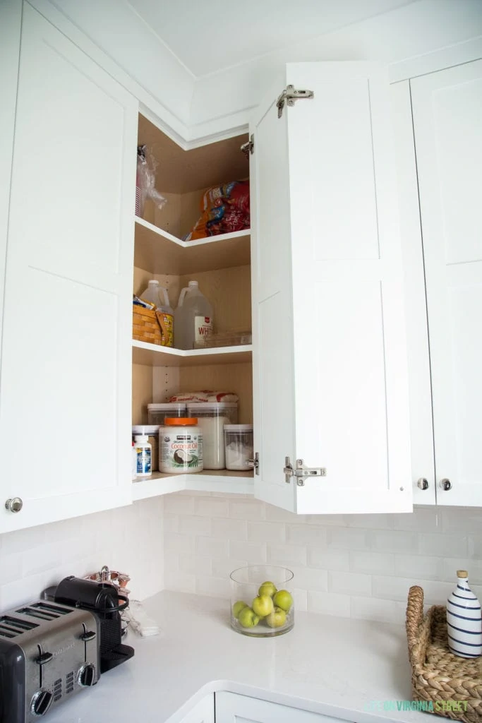 Baking supplies in the upper kitchen cabinets.