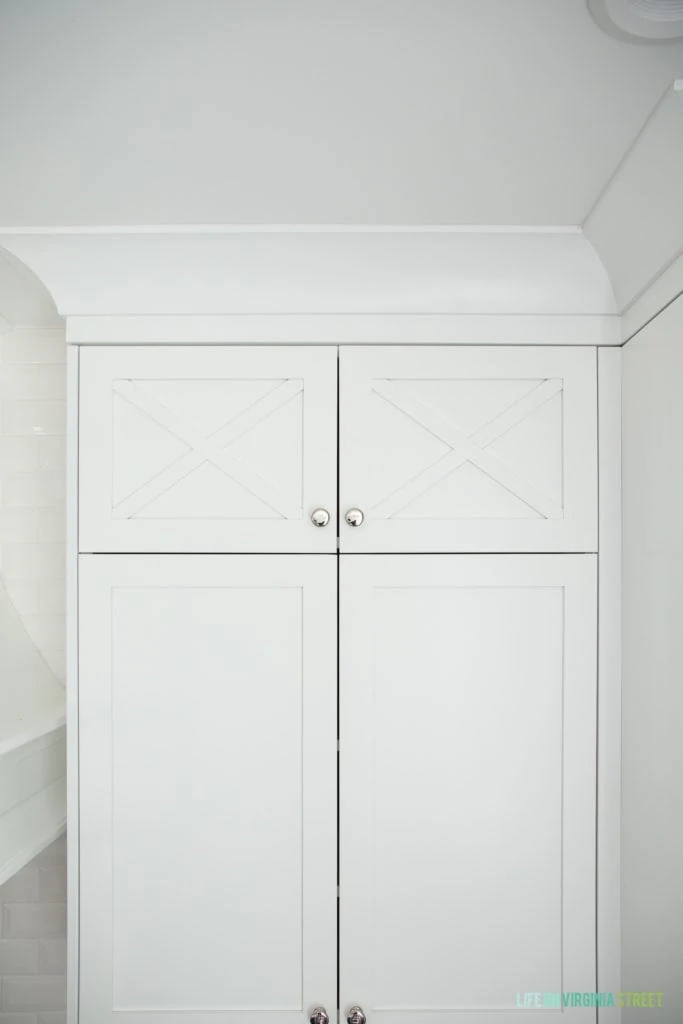 A white kitchen cabinet with silver pulls.