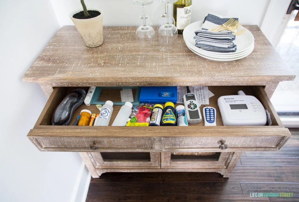 Th open drawer with pool items in it.