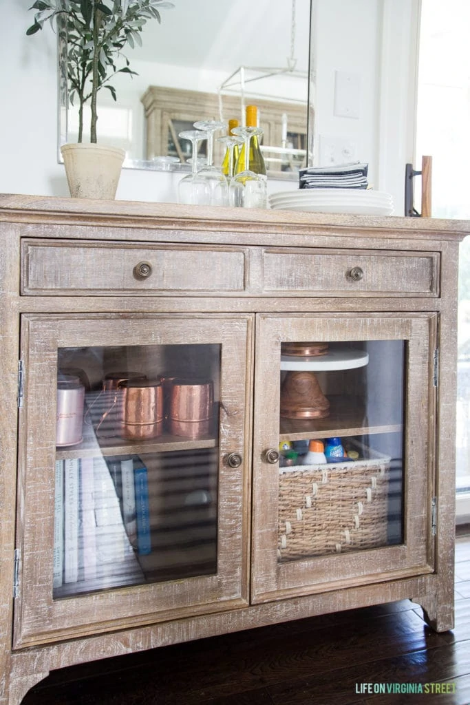 Wooden hutch with glass front doors and two drawers.