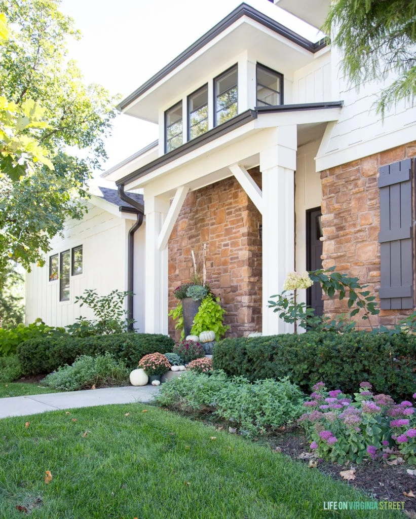 White exterior of house with stone siding.