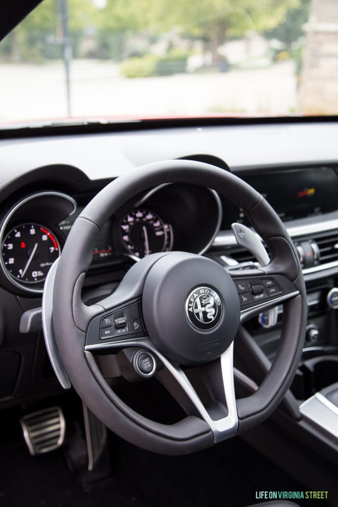 The inside of the Alfa Romeo showcasing the steering wheel.