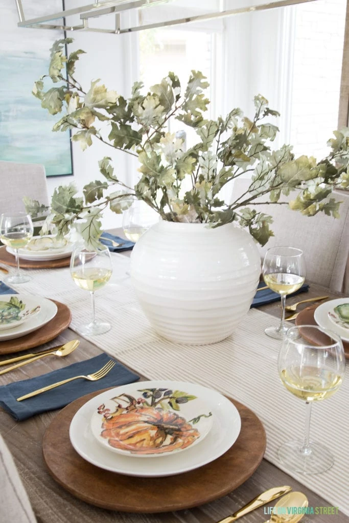 A faux oak leaf centerpiece in a beautiful Thanksgiving or fall tablescape!