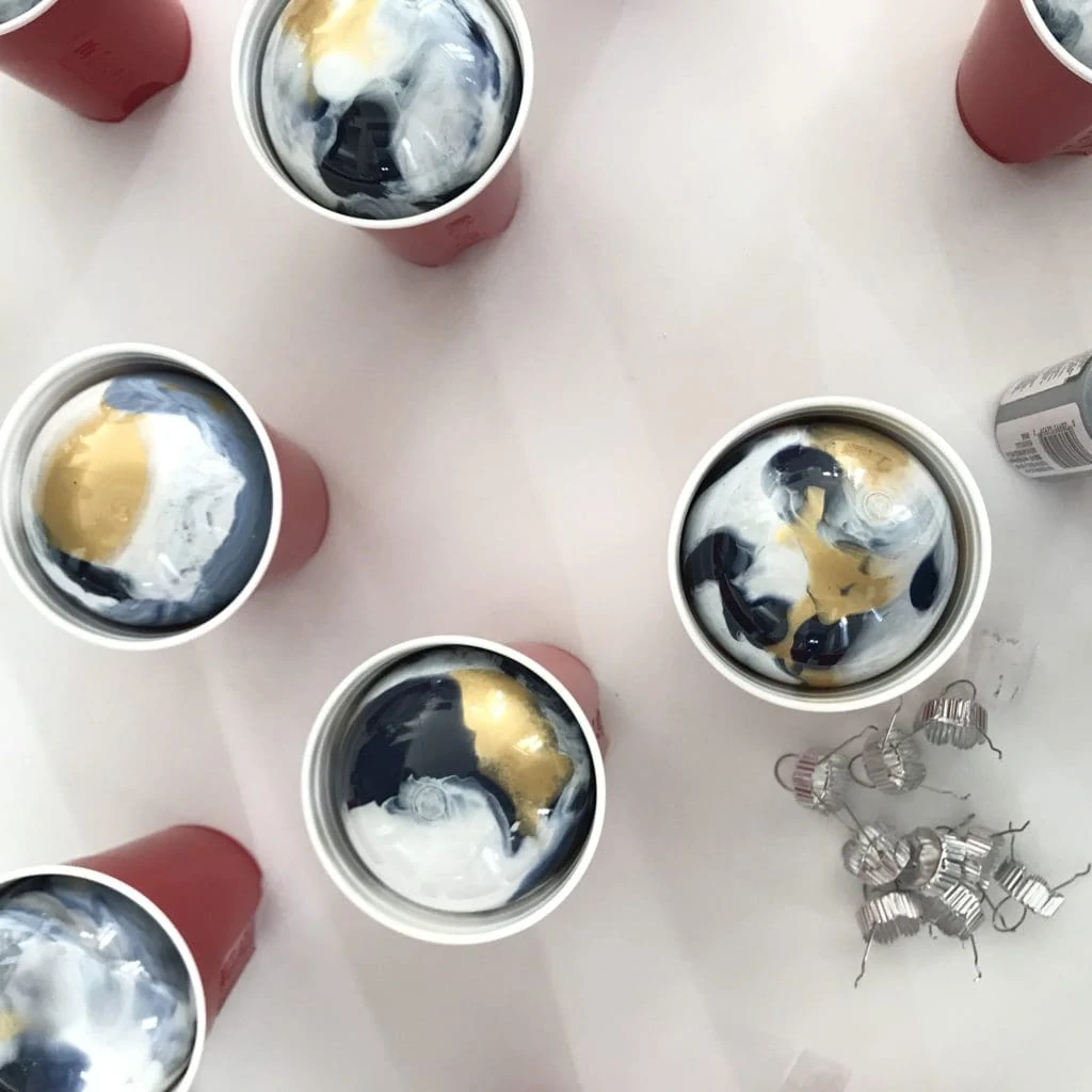 The ornaments in plastic cups drying.