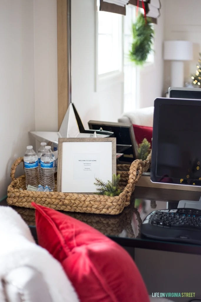 Bottled water on the small desk beside the computer in the guest bedroom.