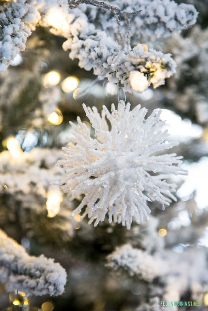 White spiky ornament on flocked tree.