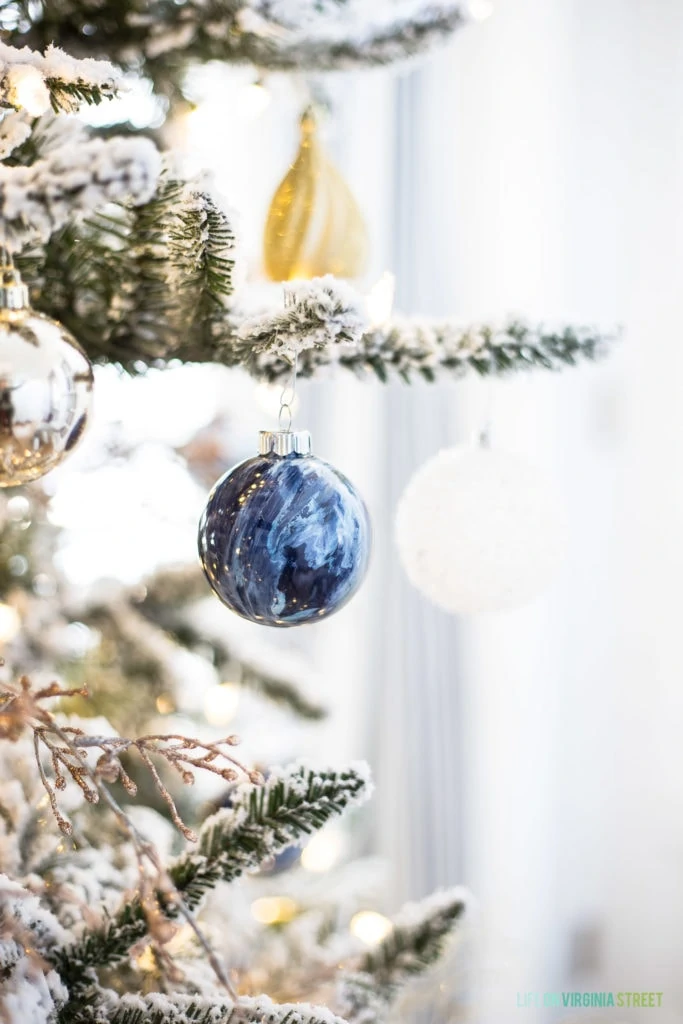 Blue marbled ornament hanging on the Christmas tree.