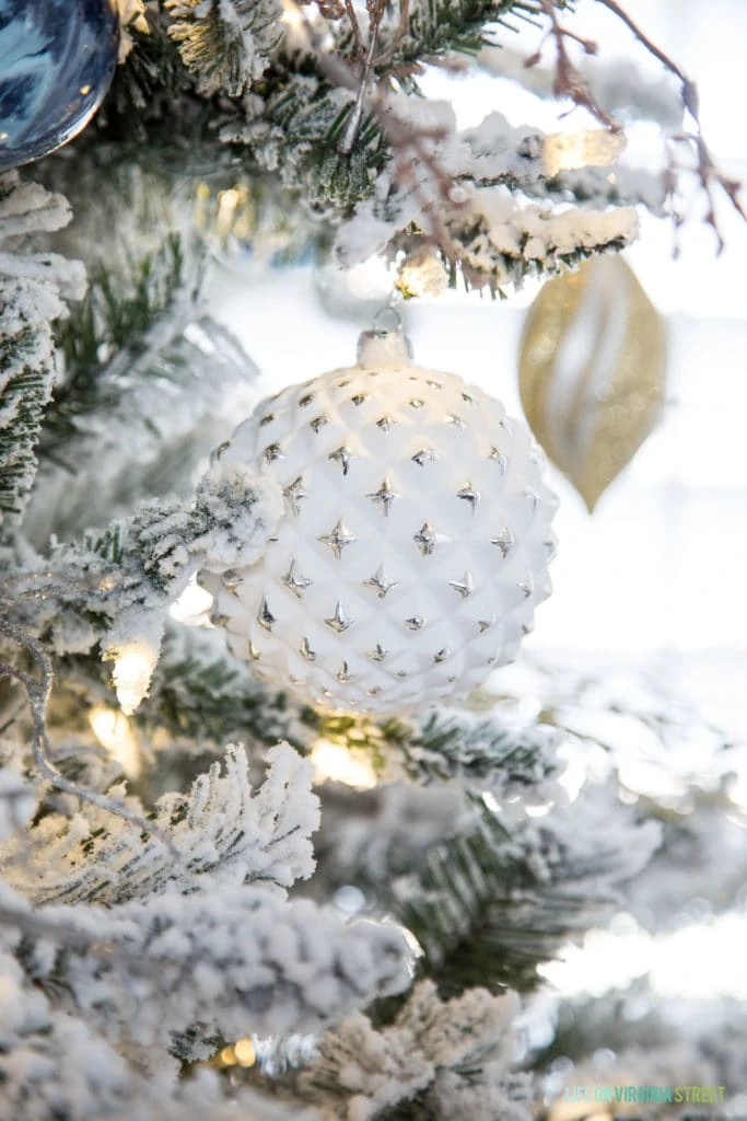 White Christmas ornament on tree.